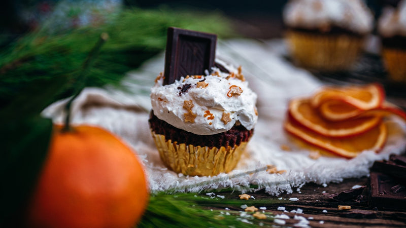 Orange ginger chocolate cupcakes with coconut cream, sprinkled with coconut